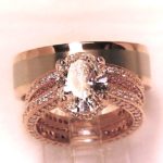 Custom designed and Hand Made in Rose and White Gold with 2 .23 C. Center Oval.